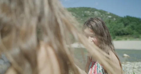 Sisters eating cherry's together at the river in pont du diable occitanie Stock Footage 132082533