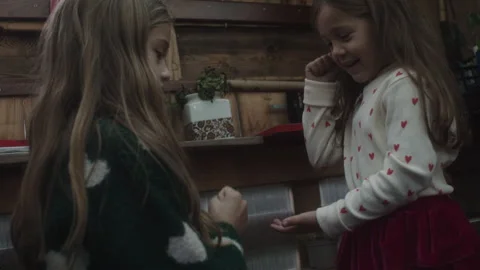 Sisters enjoy a fun game of rock paper scissors indoors together Stock Footage 320029164