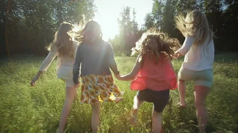 Sisters Hold Hands And Run Through A Field (Slow Motion) One Trips And Falls Video stock 42906945