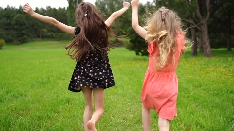 Sisters Hold Hands And Run In Slow Motion Through Beautiful Meadow, Stock Footage 210225827