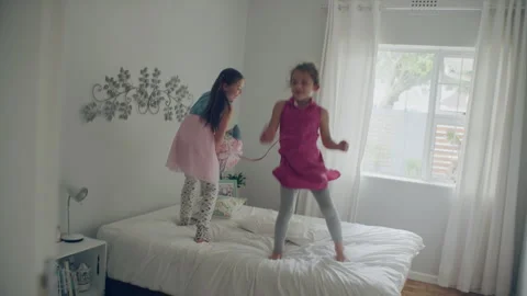 Sisters playing in the bed and dancing Stock Footage 279726132