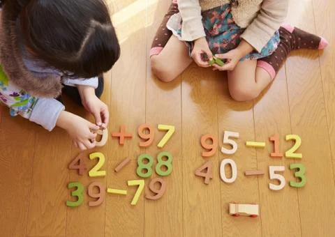 Sisters playing with number blocks Stock Photos