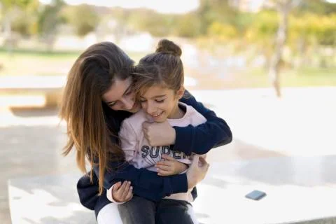 Sisters playing in a park. Stock Photos