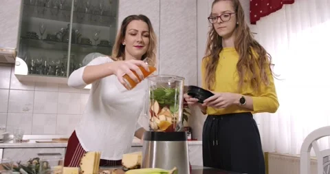 Sisters preparing healthy breakfast at kitchen Stock Footage 145825814