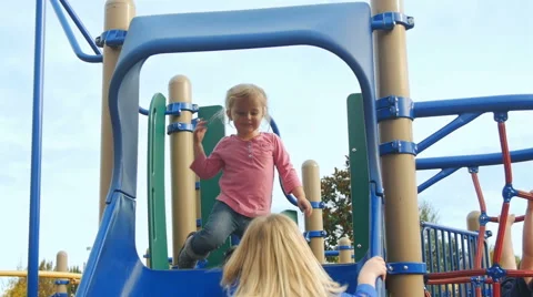 Sisters sit at the top of the slide Stock Footage 58637244