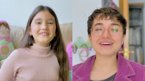 Sisters talk happily through a videoconference Stock Footage 148781598