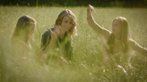 Sisters Throw Grass At Each Other In A Beautiful Sunlit Meadow Vidéo 42476912