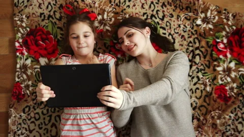 Sisters together look in order to tablet Stock Footage 90056851