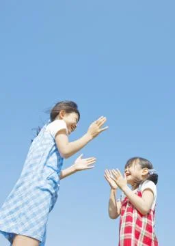 Sisters under blue sky Stock Photos