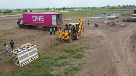 On site delivery solar power module boxes putting in array Stock Footage 314369886
