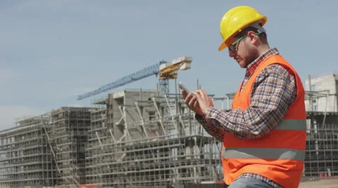 Site manager texting message in his construction yard Stock Footage 63091866