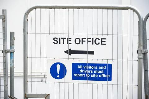 Site office direction sign on construction building site door entrance fence Stock Photos