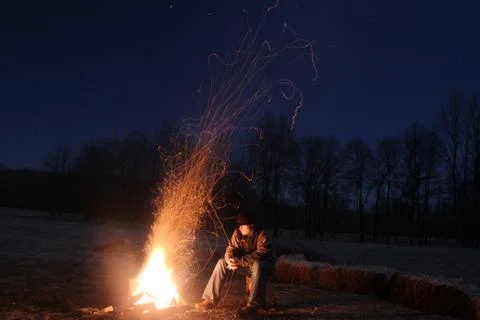 Sitting along looking at fire Stock Photos