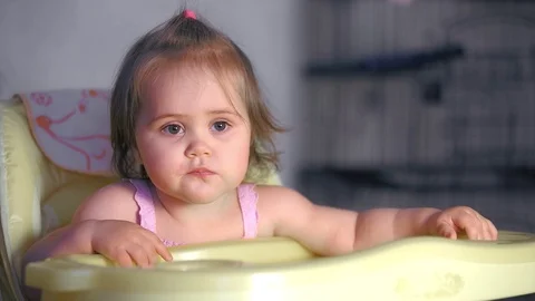 Sitting baby eats Stock Footage 98699762