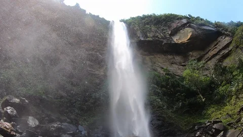 Sitting at the base of a beautiful waterfall Stock Footage 128603450