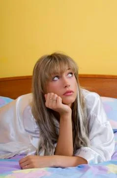 Sitting on the bed Stock Photos