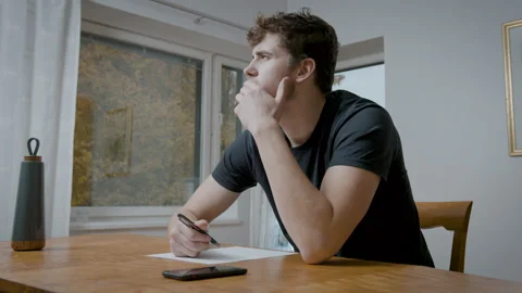 Sitting Behing The Desk And Thinking About Ideas To Write. Video stock 162403773