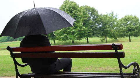 Sitting on bench during rain and go. Stock Footage 39655959