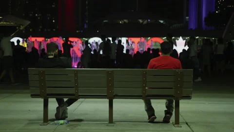 Sitting on a bench in Nathan Phillips Square, at night Stock Footage 217958840