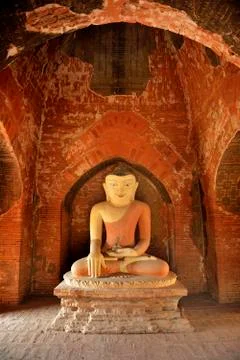 Sitting Buddha statue inside one of hundred old temples in Bagan, Myanmar Stock Photos