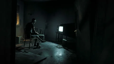 Sitting on a chair is a skeleton of a man in front of a television set that Stock Footage 193985791