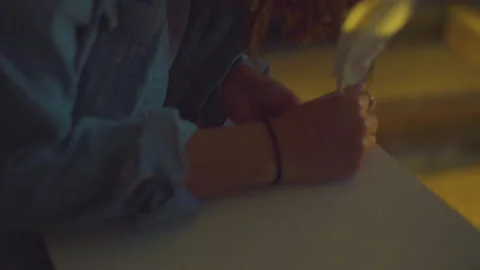 Sitting in chair to write Stockbeeldmateriaal 171724012