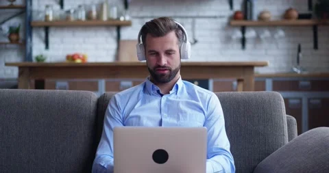 Sitting on couch using laptop notebook looking at screen typing message, focused Stock Footage 160328187