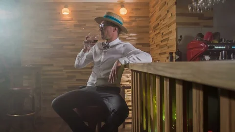 Sitting at a counter bar by himself and having a drink Video stock 112192129