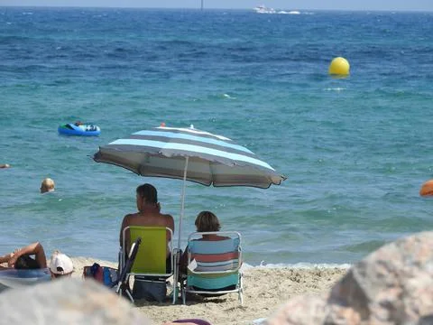 Sitting on deck chairs Stock Photos