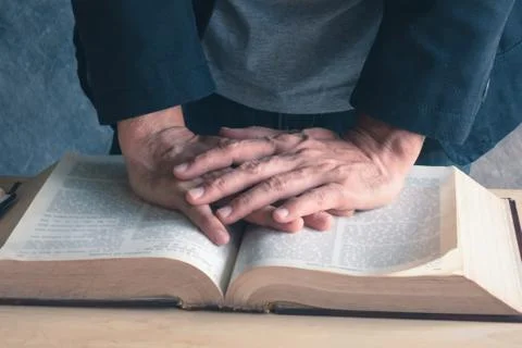 Sitting at a desk with a stack of books Stock Photos