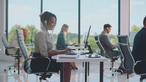 Sitting at desk, typing and speaking Stock-Footage 164579378