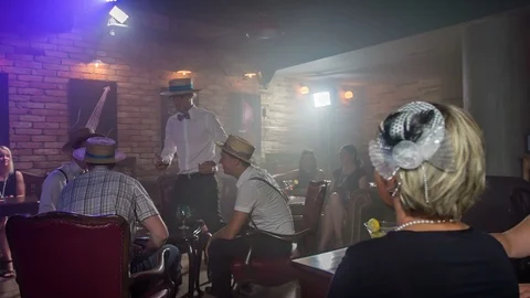 Sitting down with the boys and bringing some drinks Stock Footage 112185880