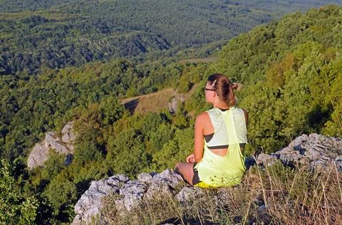 Sitting on the edge of the rock Stock Photos