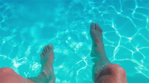 Sitting on the edge of a swimming pool Video stock 40619125