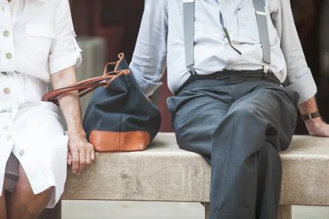 Sitting elderly couple on bench Stock Photos