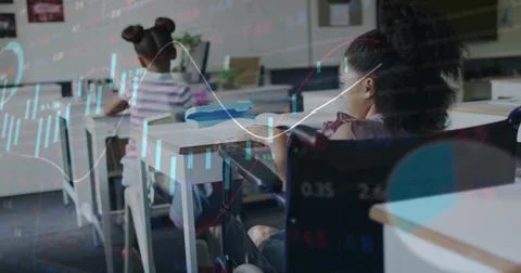 Sitting front pupil wearing patterned top, using wheelchair at desk in classroom Stock Photos