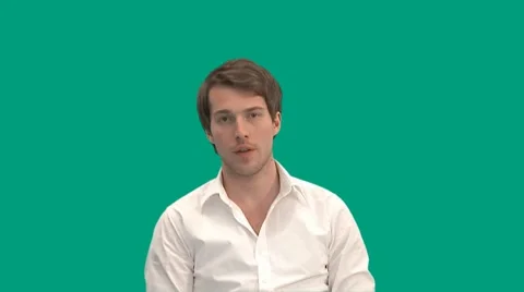 Sitting guy gets a call on his mobile phone - green screen - pre keyed - MINT.GS Video stock 8646720