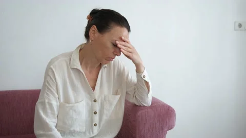 Sitting indoor with a powerful headache. Stock Footage 231926543