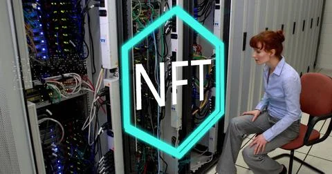 Sitting IT tech managing cables near server racks in server room, with NFT Foto stock