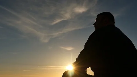 Sitting in lotus posture man playing a drum silhouette camera distancing Stock Footage 89461580