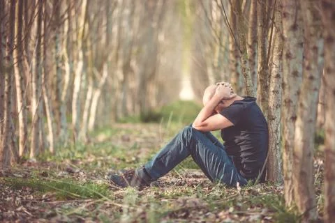 Sitting man with depression going through a rough patch in his life, suffering 库存照片