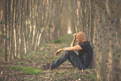 Sitting man with depression going through a rough patch in his life, suffering Фото