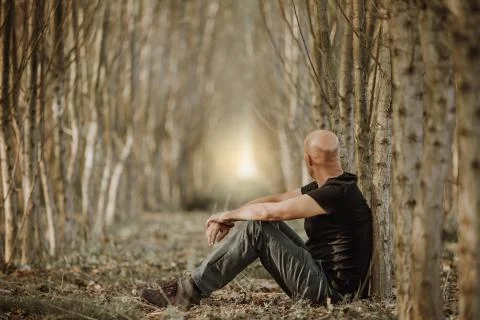 Sitting man with depression going through a rough patch in his life, suffering 库存照片