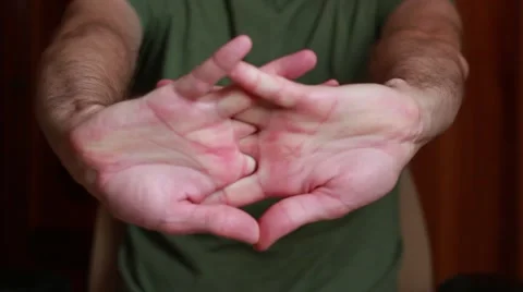 Sitting man makes stretch-hands exercises Stock Footage 65371716