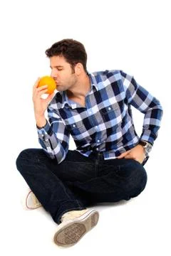 Sitting man with an orange Stock Photos