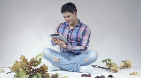 Sitting man using a digital tablet Видео 42673803