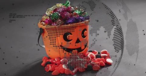 Sitting orange jack-o-lantern bucket holding foil candies on matte tabletop, Stock Photos