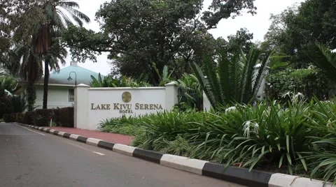 Sitting outside front gate of lake kivu hotel Stock Footage 47887034