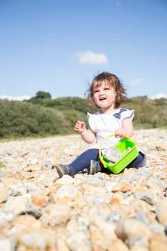 Sitting on a pebble beach Stock Photos