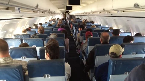 Sitting on a plane towards back lots of people Stock Footage 74504406